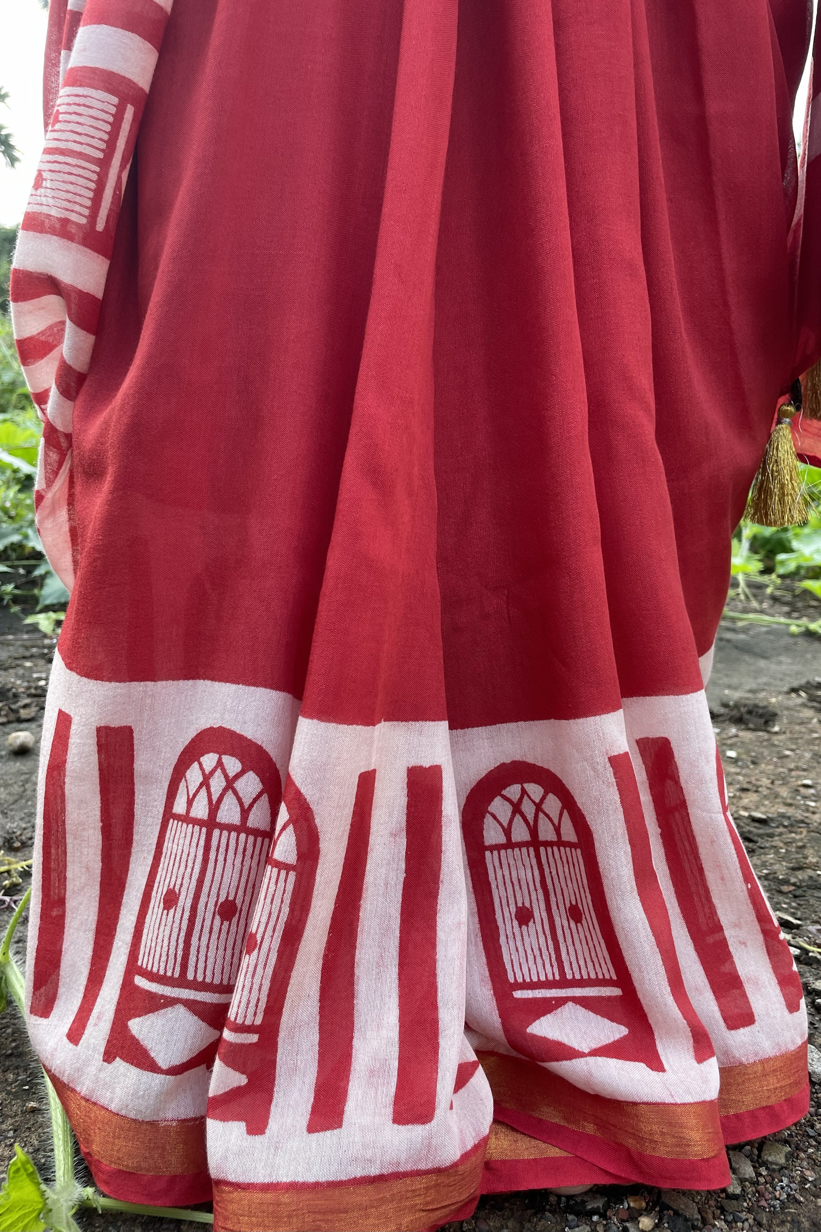 Red Mogasu chanderi silk saree details with white Goan window patterns on a natural background