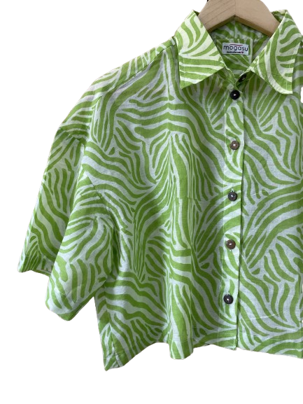 Green and white patterned Mogasu shirt on a hanger with a visible brand label.