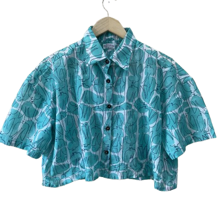 Blue patterned Mogasu shirt on a hanger against a white background