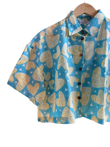 Blue Mogasu shirt with yellow butterfly pattern on a hanger