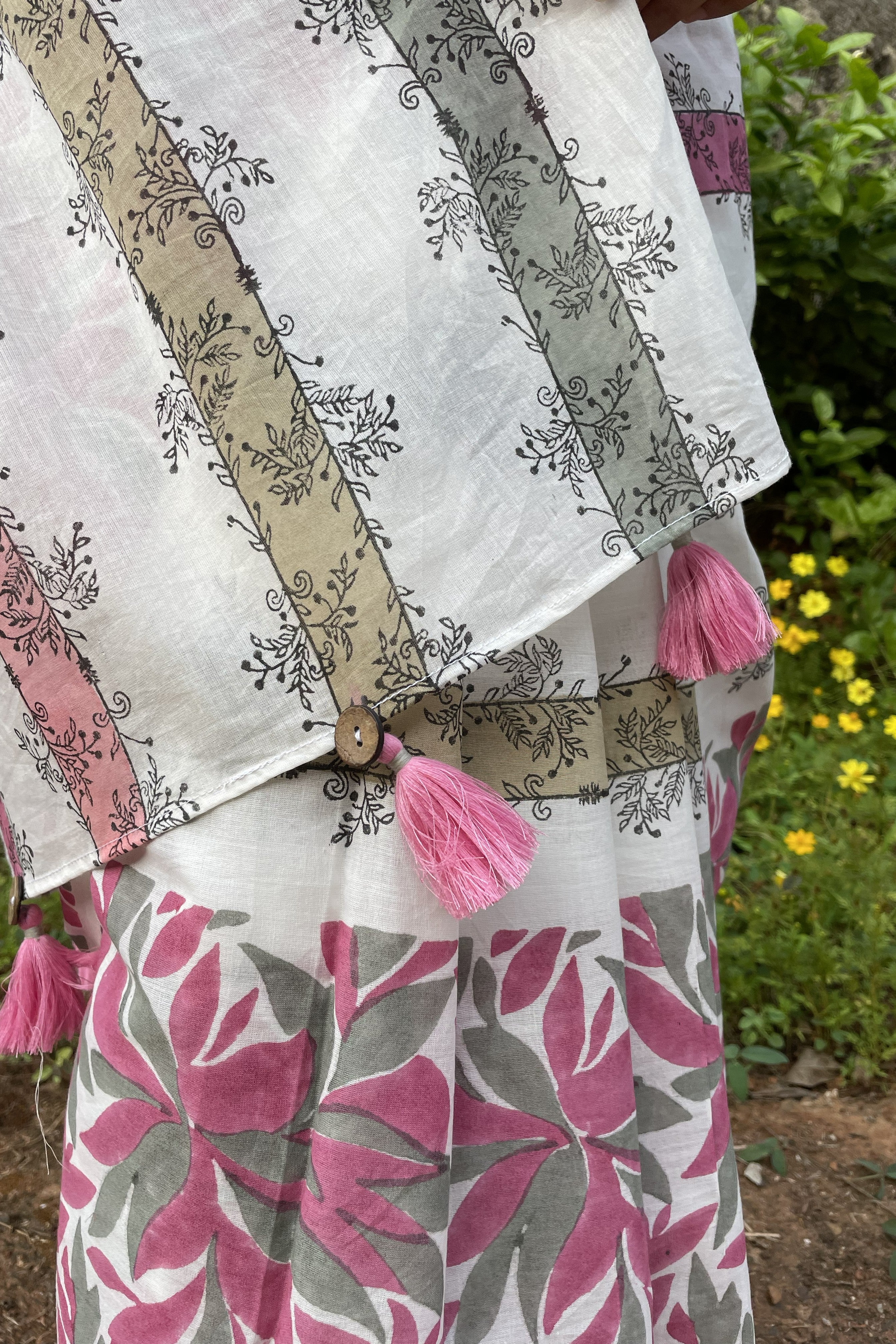 Floral Mogasu mul cotton saree with pink tassels and a patterned design on a white background