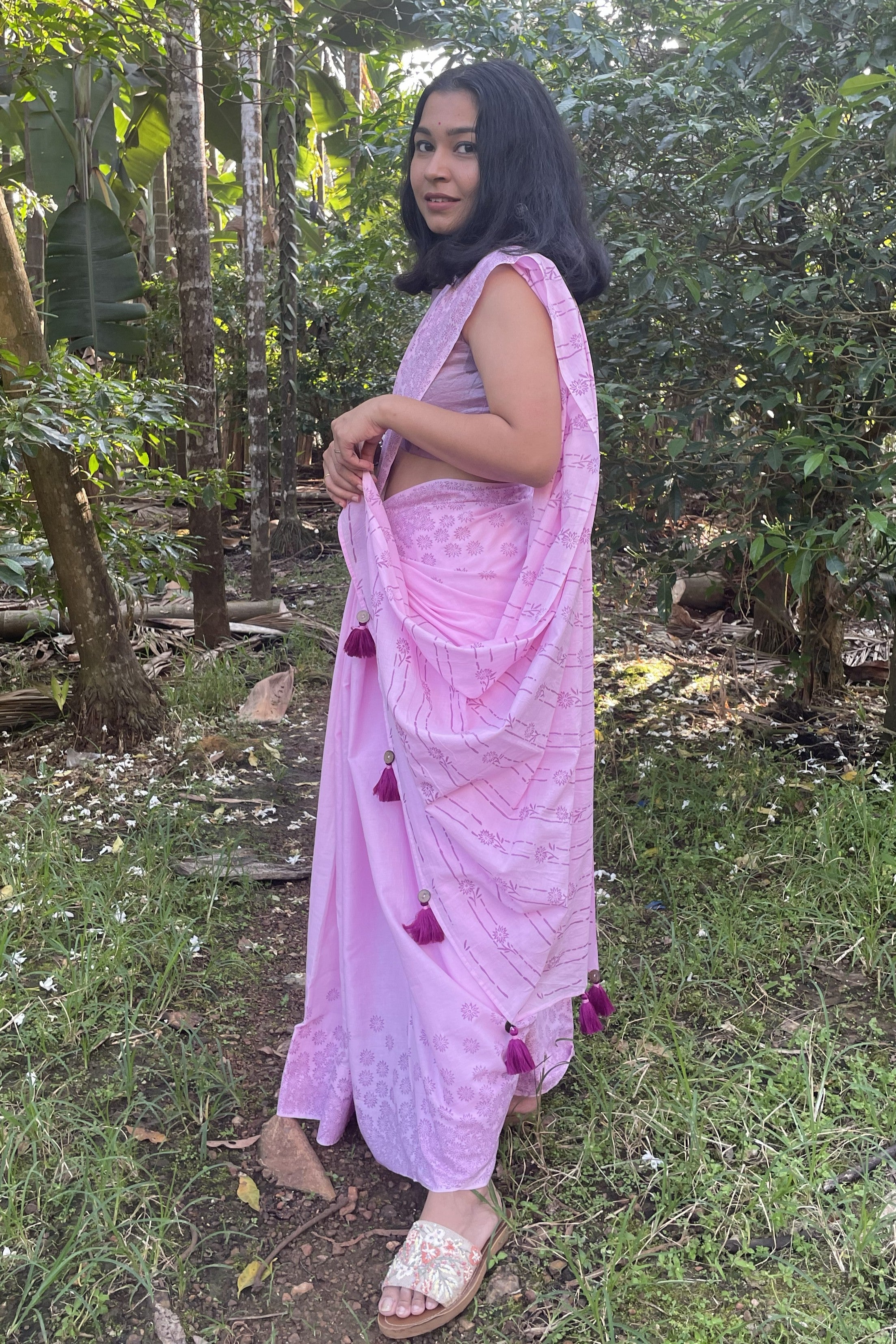 Woman in a Mogasu pink saree with a forest background in Goa