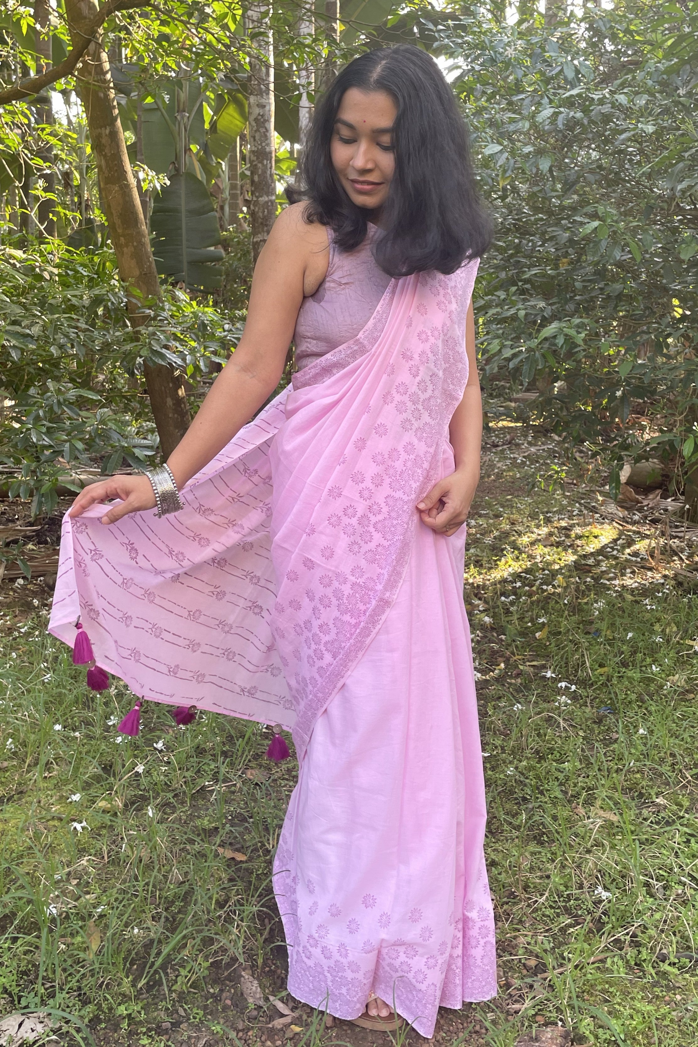 Woman in a Mogasu pink saree standing in a forest in Goa