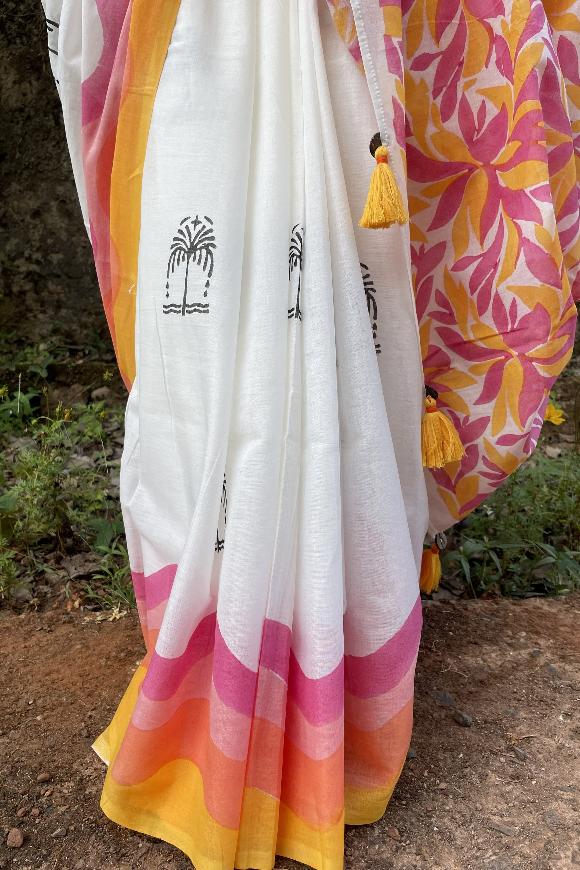 Colourful Mogasu mul cotton saree with white background, pink and yellow patterns.