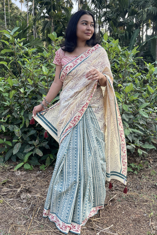 Woman wearing a Mogasu saree in a natural setting with greenery in Goa.
