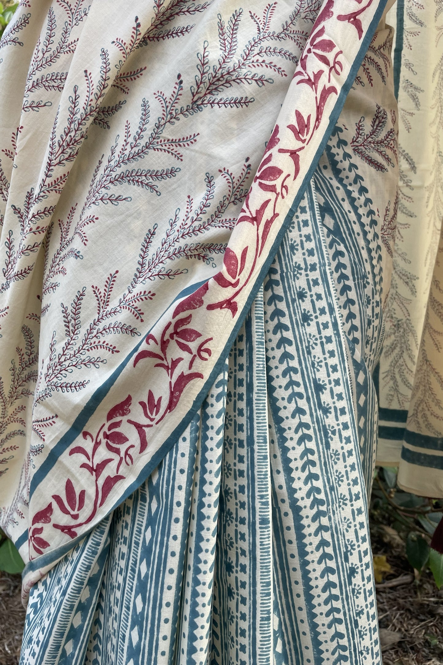 Close-up of patterned geometric saree with floral and striped designs. A saree from a Goan brand Mogasu