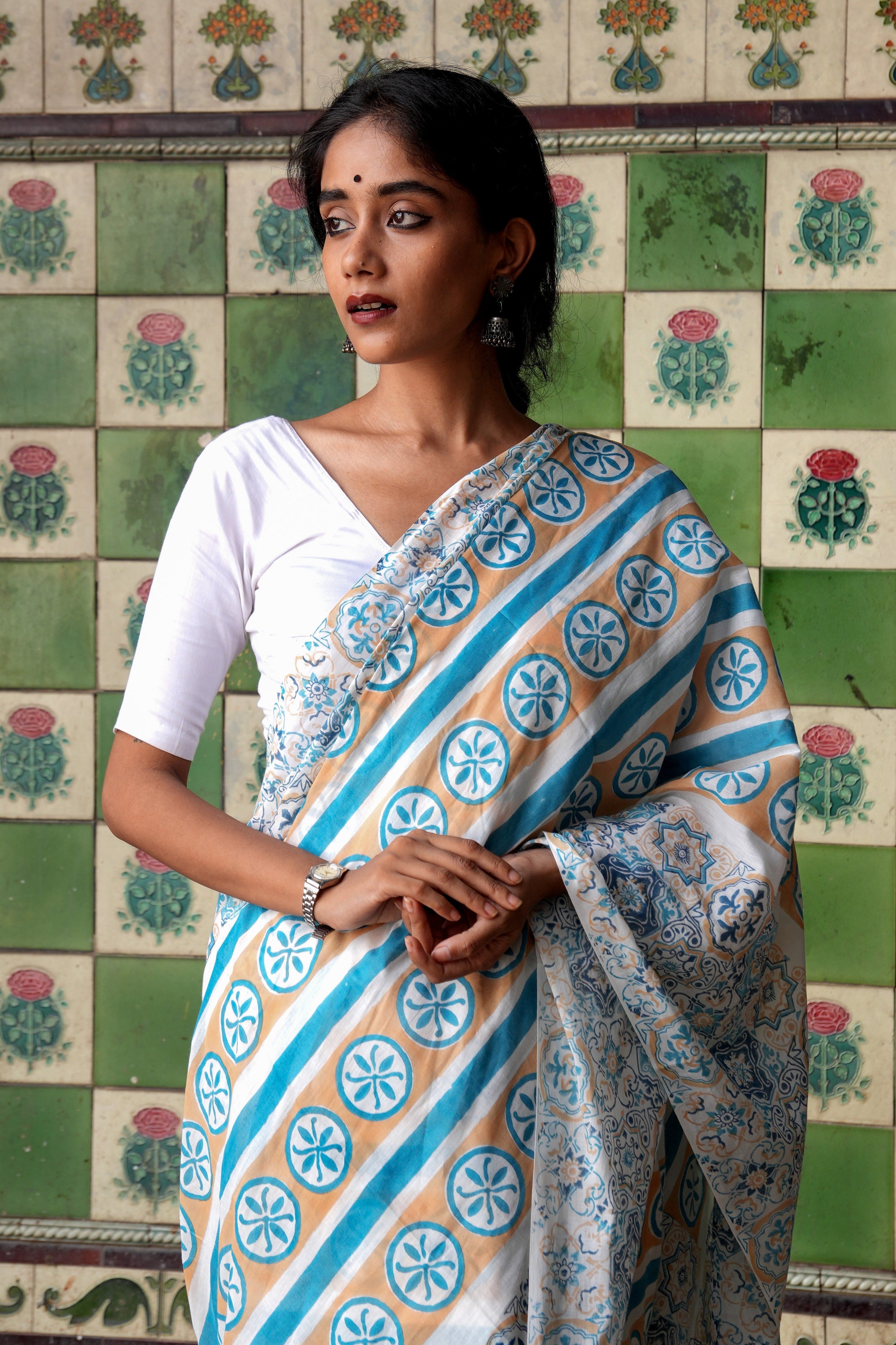 Woman wearing a traditional Goan Azulejo saree with a patterned background