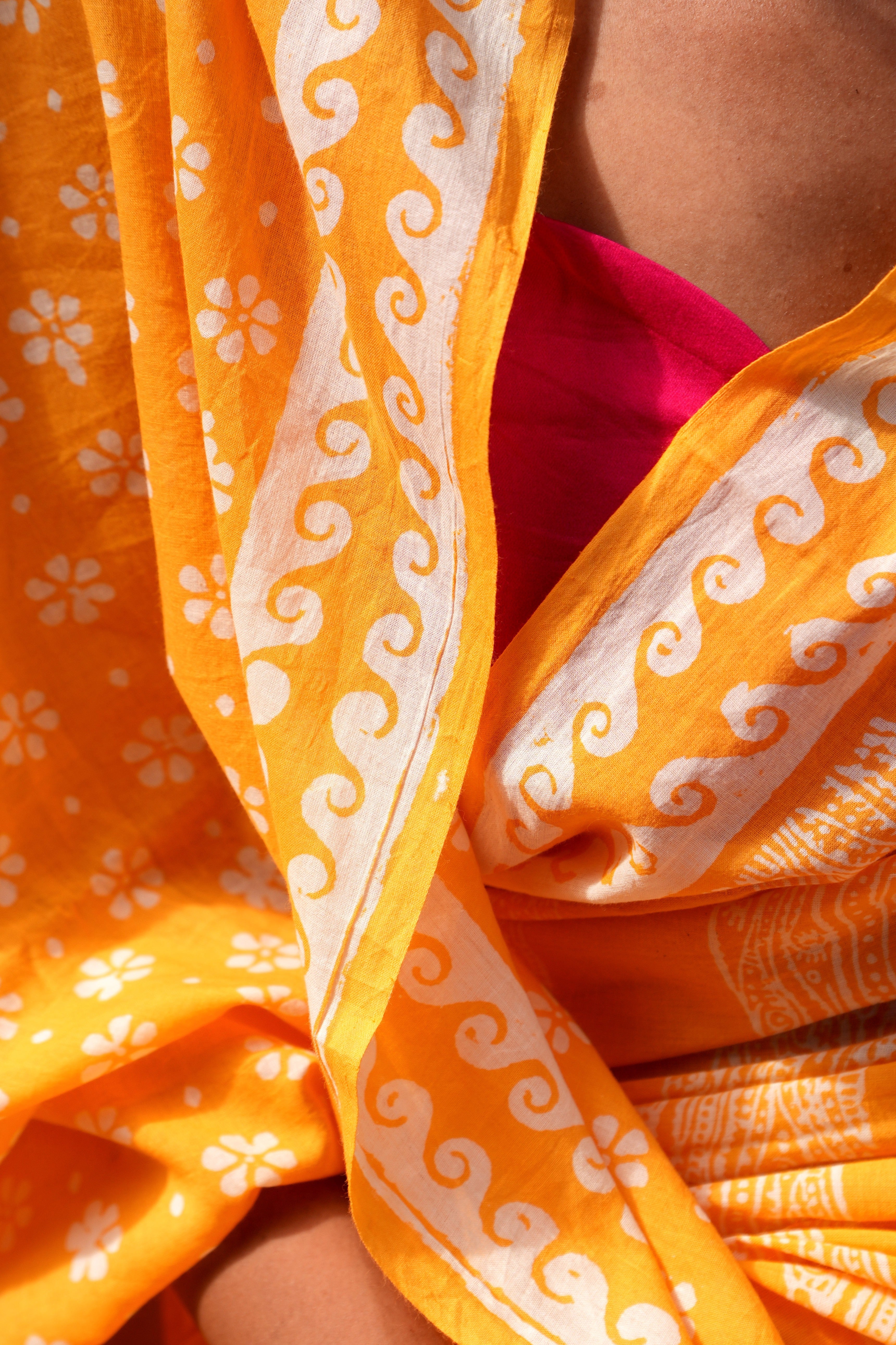 Close-up of yellow Mogasu Brisa saree with white patterns