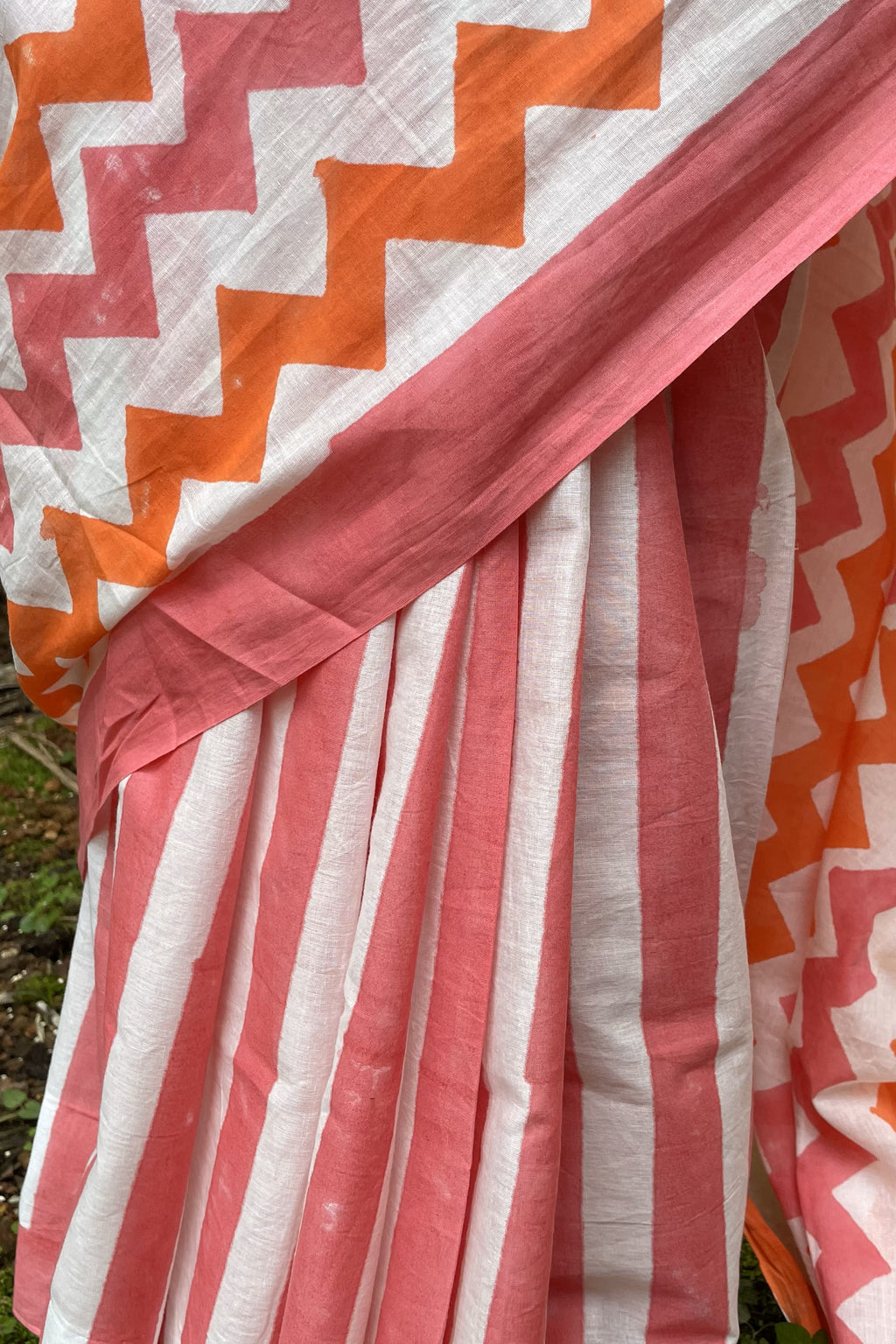 Close-up of a Mogasu saree with pink and orange zigzag pattern