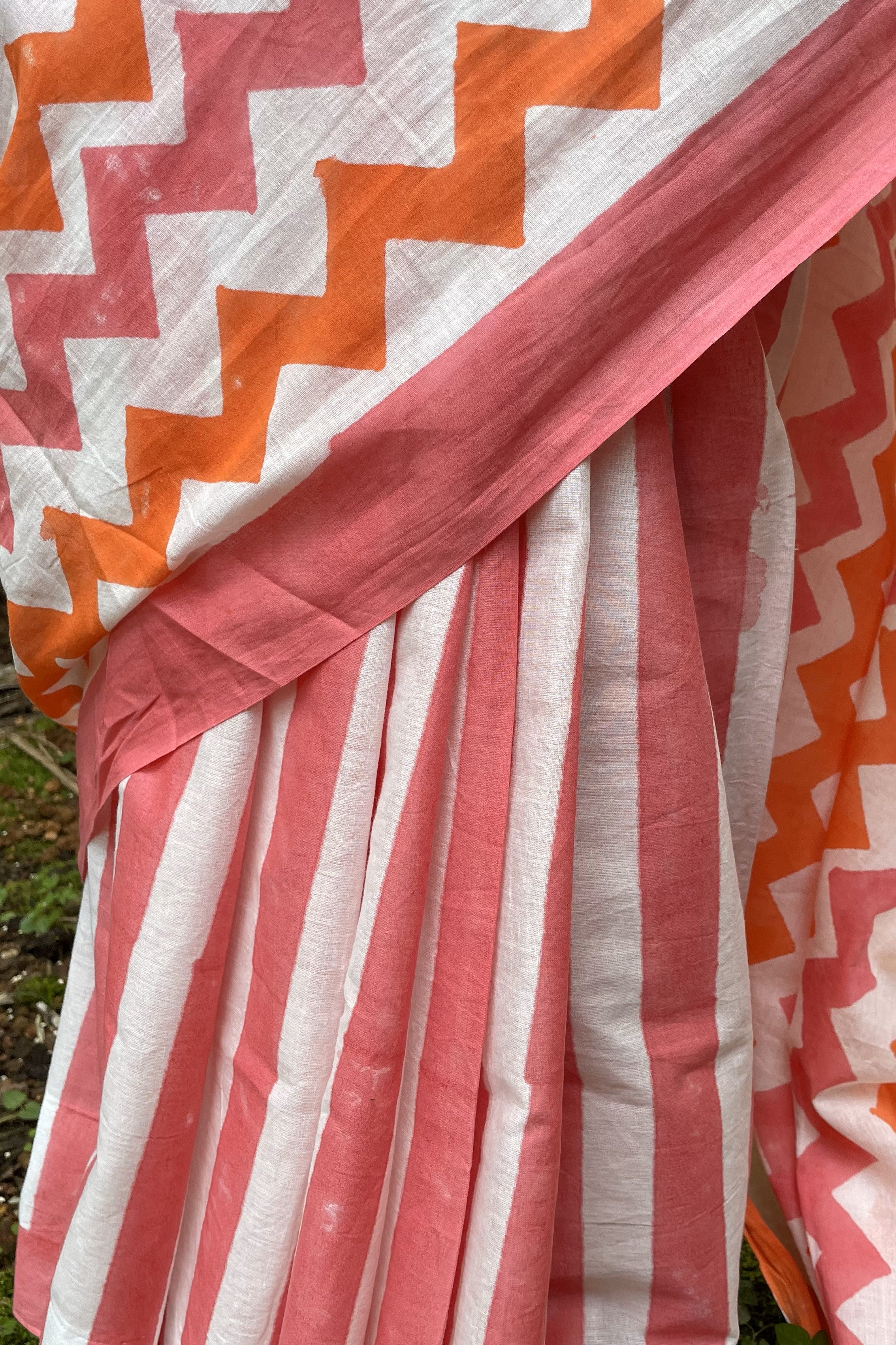 Close-up of a Mogasu saree with pink and orange zigzag pattern